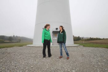zwei Frauen vor Windkraftanlage