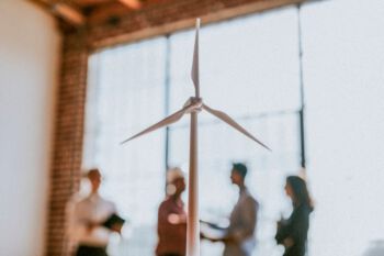Eco-friendly engineering team standing by a the glass window