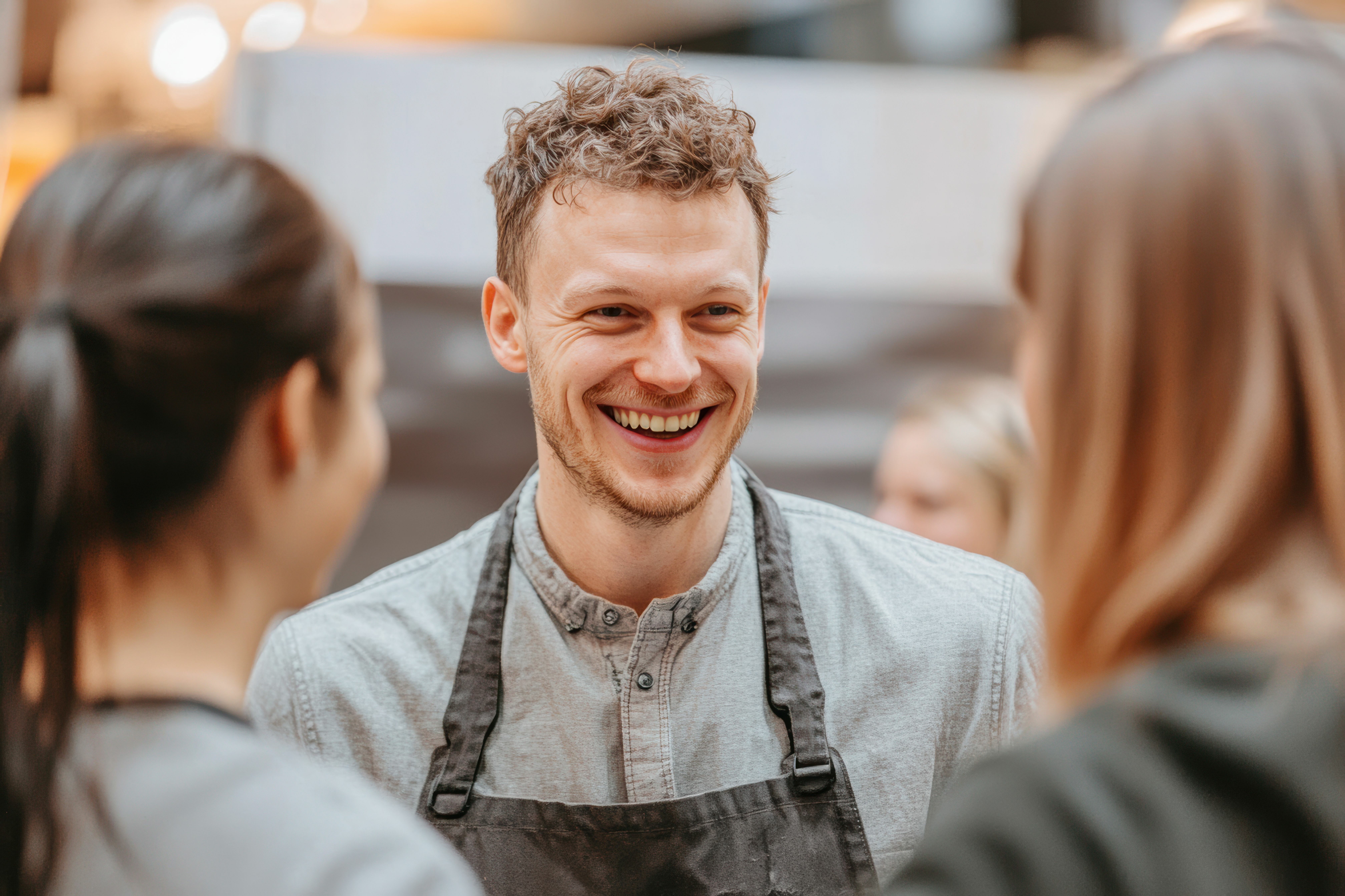 Fostering meaningful connections, a team at a trade show discusses CRM strategies alongside key insights on teamwork, sustainability, and business transformation.